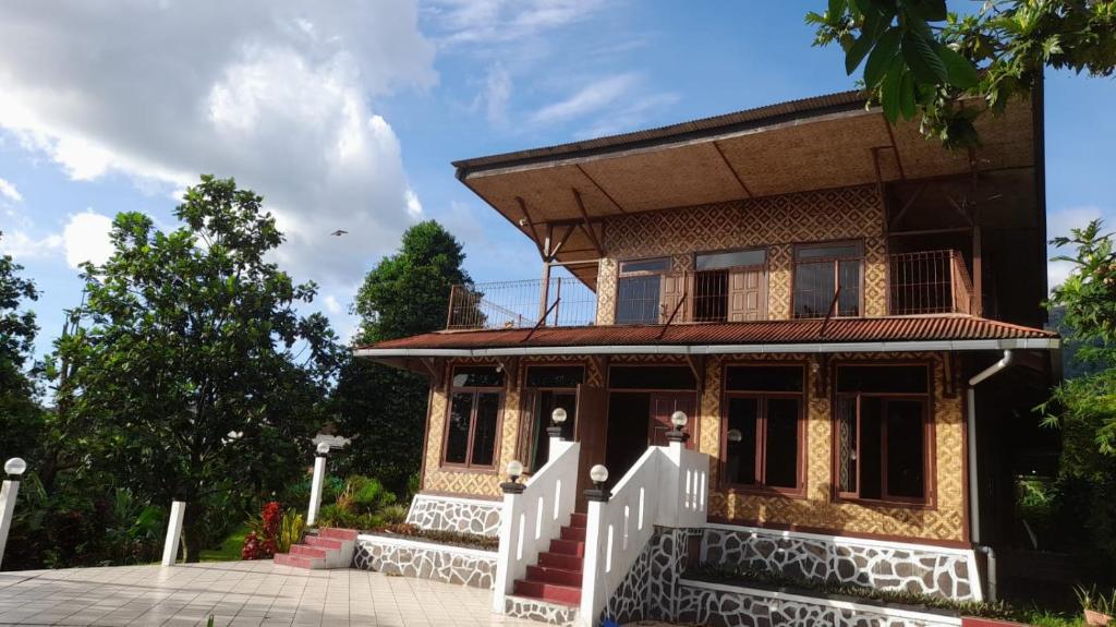 a house with a white fence in front of it at Salak Sunrise Homestead in Bogor