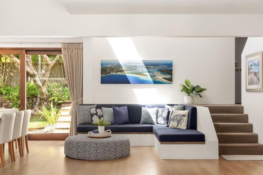 a living room with a couch and a table at Sunshine Beach Retreat, Pool, Backyard in Sunshine Beach