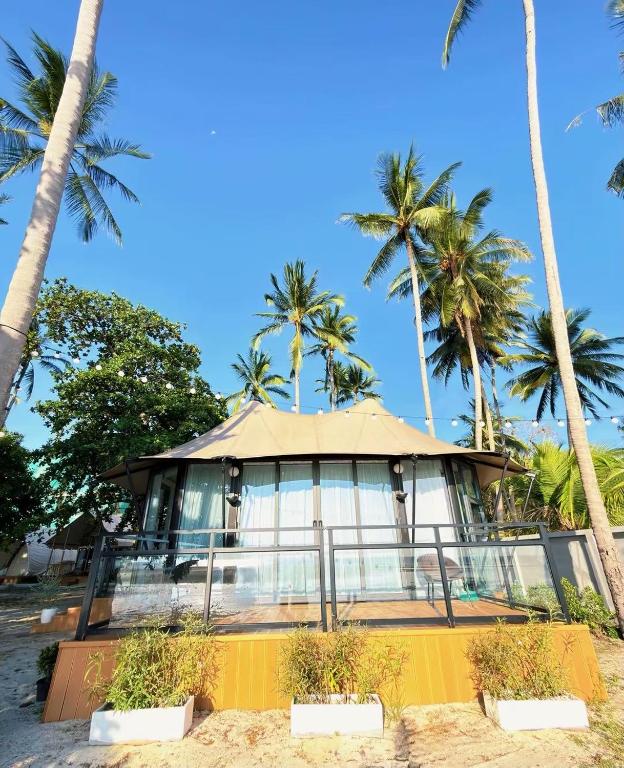 a house on the beach with palm trees at Umbrella tree V4 in Nathon