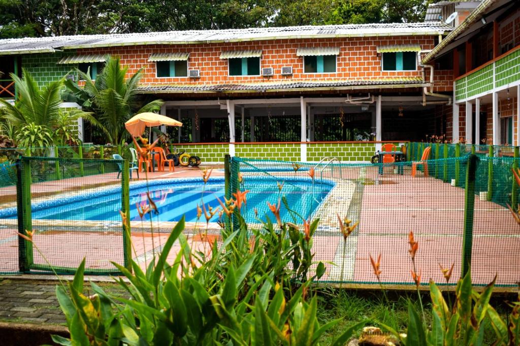 a swimming pool in front of a building at hotel con piscina Ladrilleros in Ladrilleros