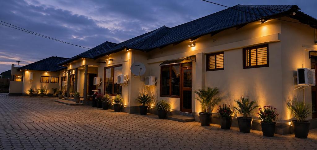 a building with potted plants in front of it at NEBCON Executive Lodge in Kitwe