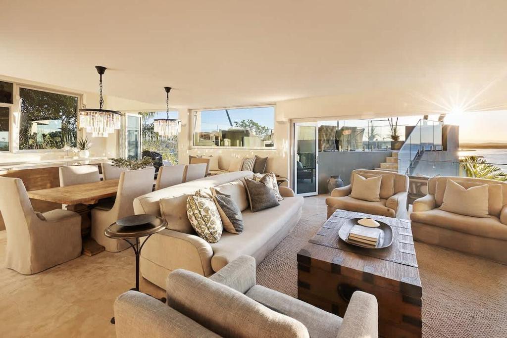 a living room with a couch and chairs and a table at Hastings Park: Lavish Ocean Vista Luxury in Noosa Heads