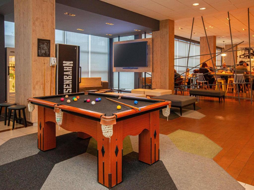 a pool table with balls on it in a lobby at ibis Recife Boa Viagem in Recife