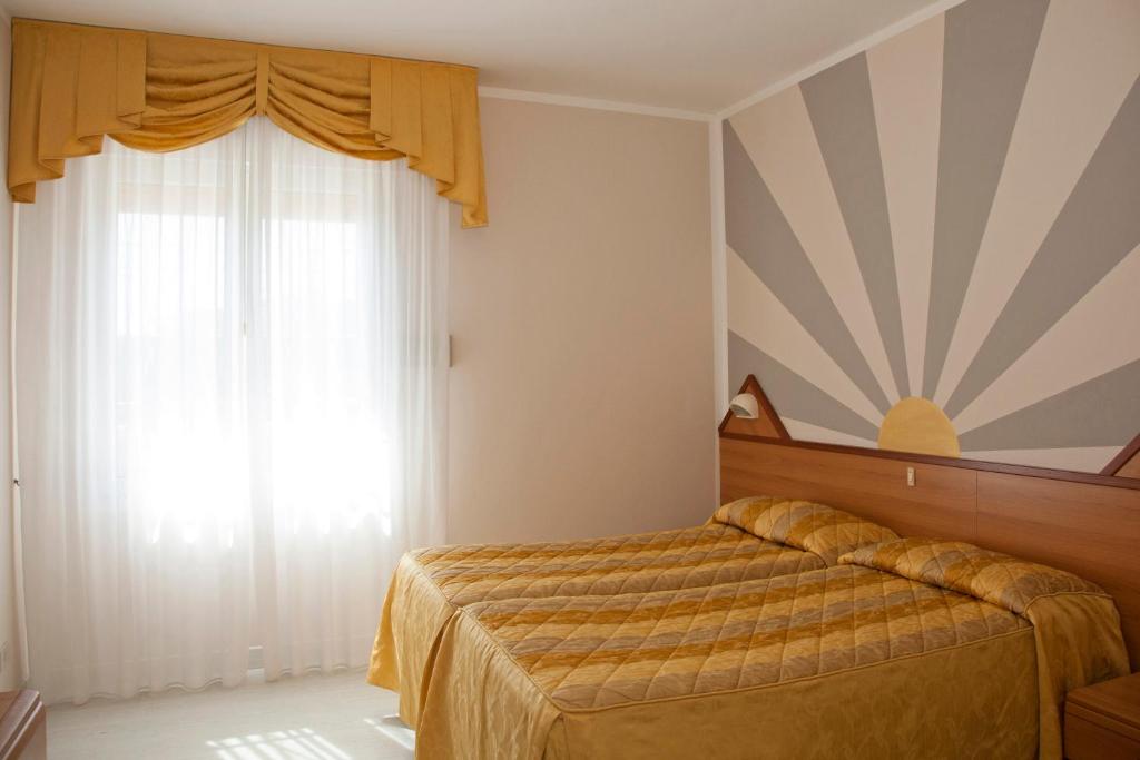 Postel nebo postele na pokoji v ubytování Hotel Righetto Fronte Mare