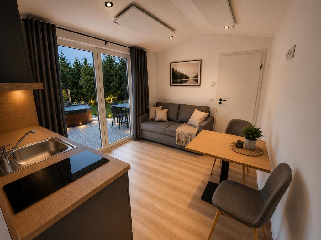 a living room with a couch and a table at Hassberge Chalets in Kirchlauter