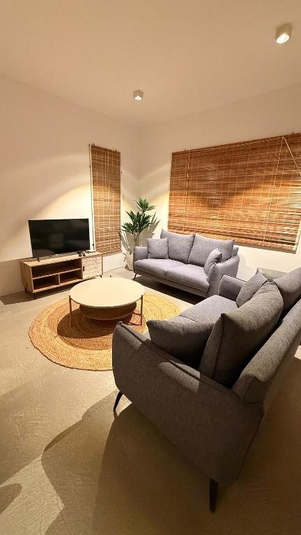 a living room with a couch and a table at La Casa Floréal in Curepipe