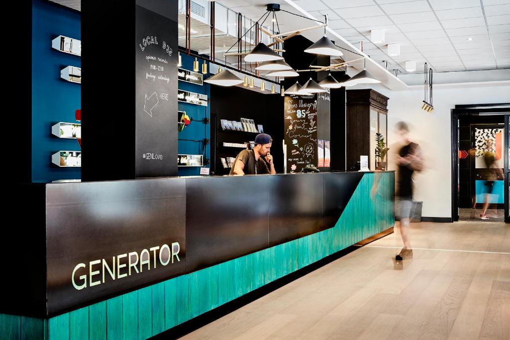 a man standing at a counter in a store at Generator Stockholm in Stockholm