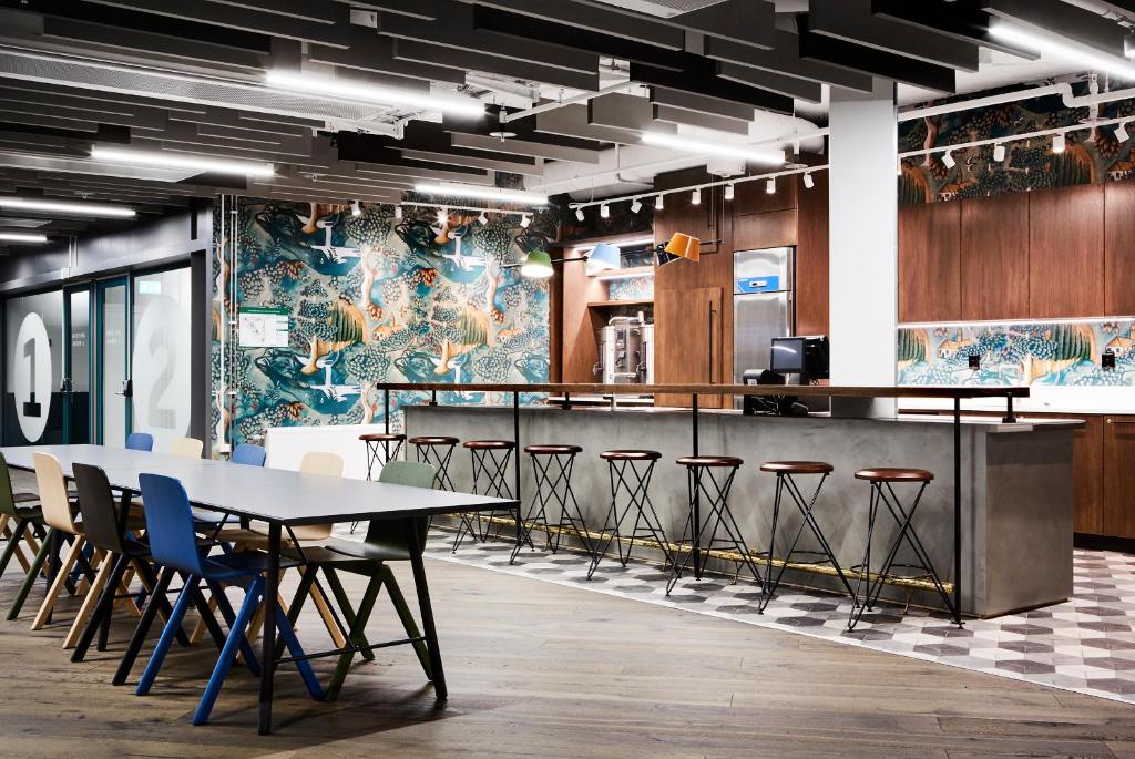 a conference room with a table and stools at Generator Stockholm in Stockholm
