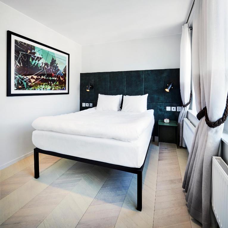 a bedroom with a large white bed in a room at Generator Stockholm in Stockholm