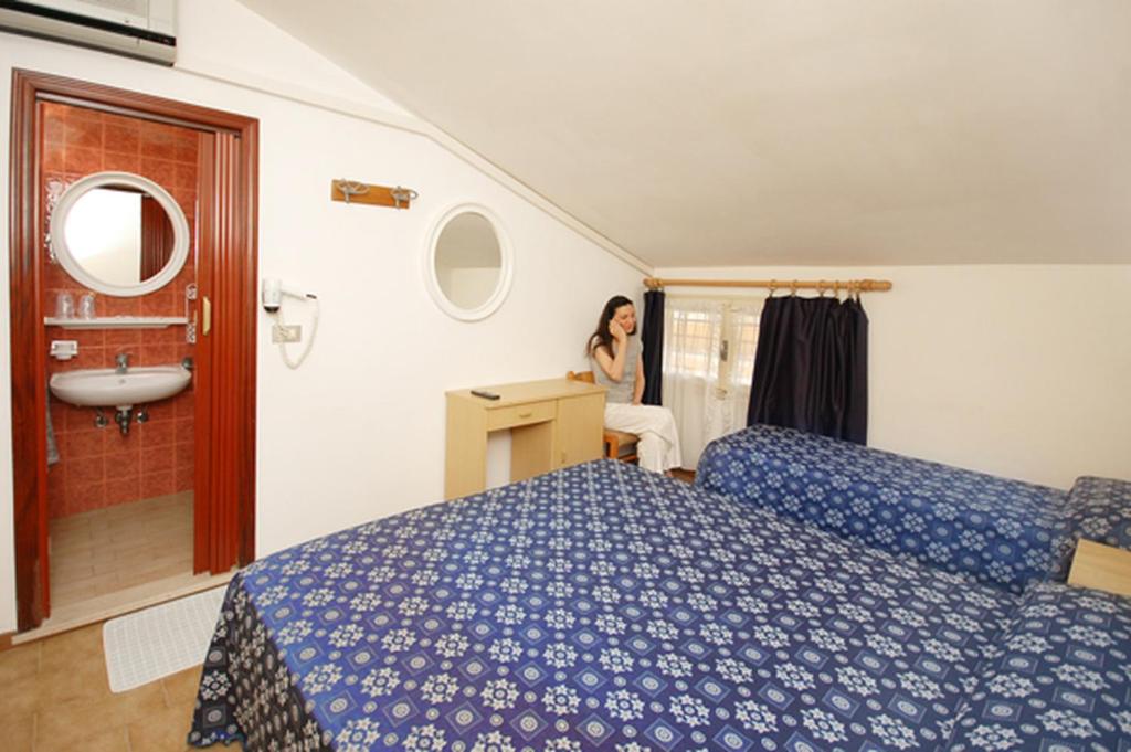 Postel nebo postele na pokoji v ubytování Hotel Marina