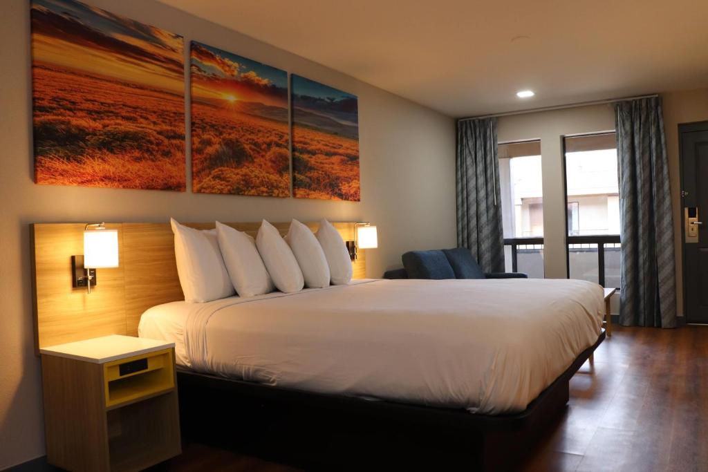 a hotel room with a large bed and a window at Days Inn by Wyndham Payson in Payson