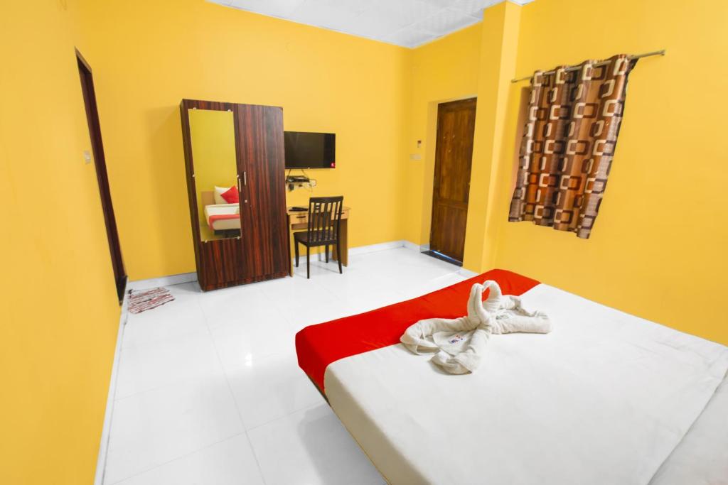 a bedroom with a bed with a stuffed animal on it at Pondy VMB Residency Starlight Hotels in Pondicherry