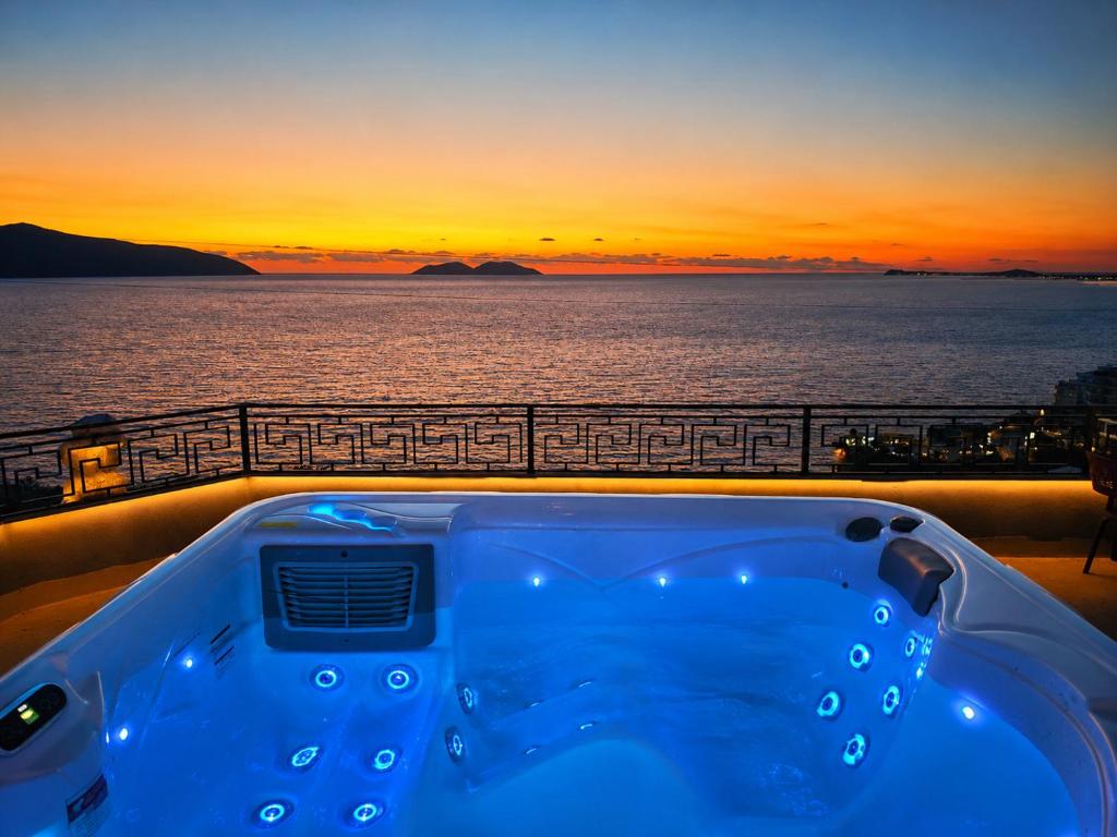 a hot tub on a cruise ship with the sunset at Villa Meminaj in Vlorë