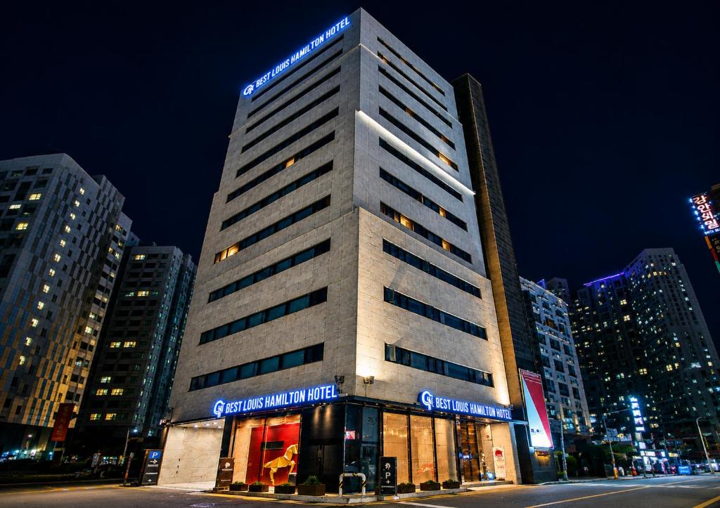 a tall building with lights on top of it at Best Louis Hamilton Hotel Haeundae in Busan
