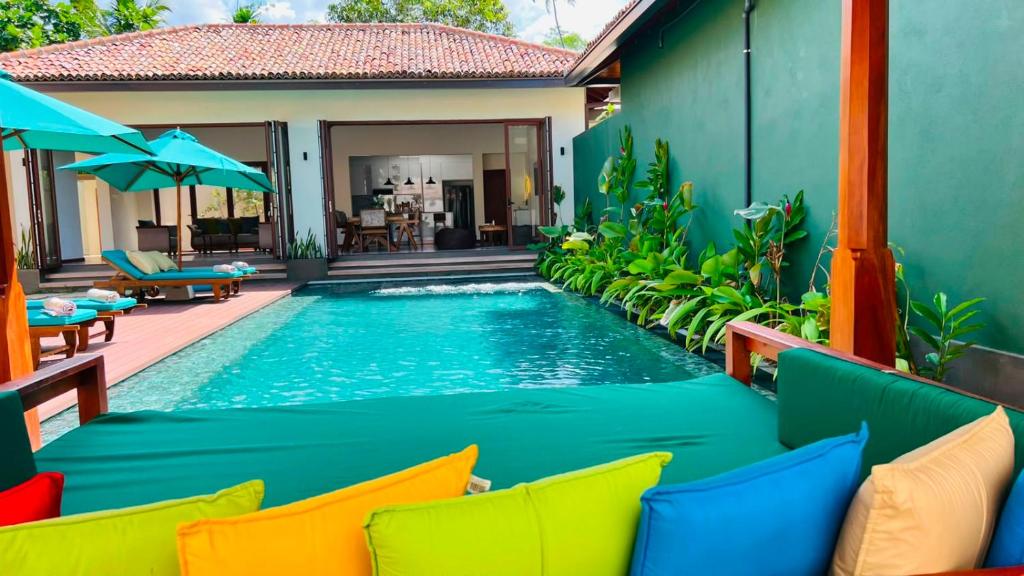 a swimming pool in front of a villa at Eden Collection Thalpe in Talpe