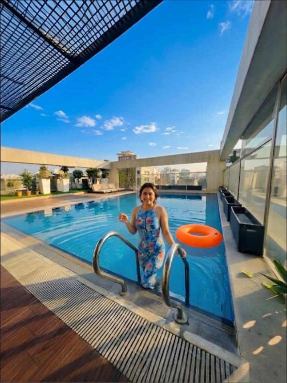 a young girl in a swimming pool with a frisbee at Dhaka Unique Regency in Dhaka