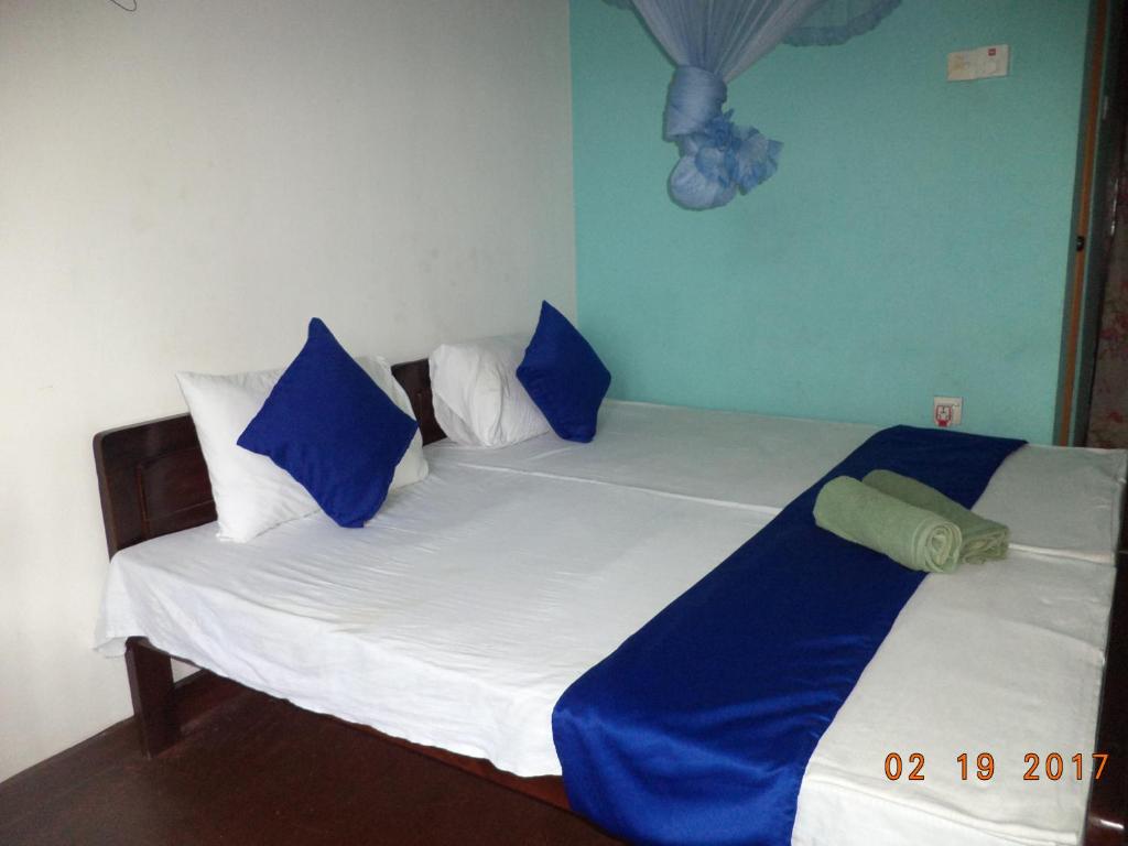 Postel nebo postele na pokoji v ubytování Raja174 Homestay