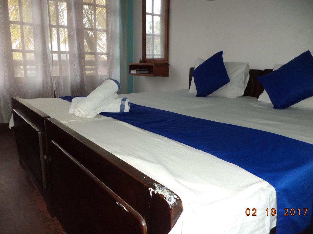 Postel nebo postele na pokoji v ubytování Raja174 Homestay