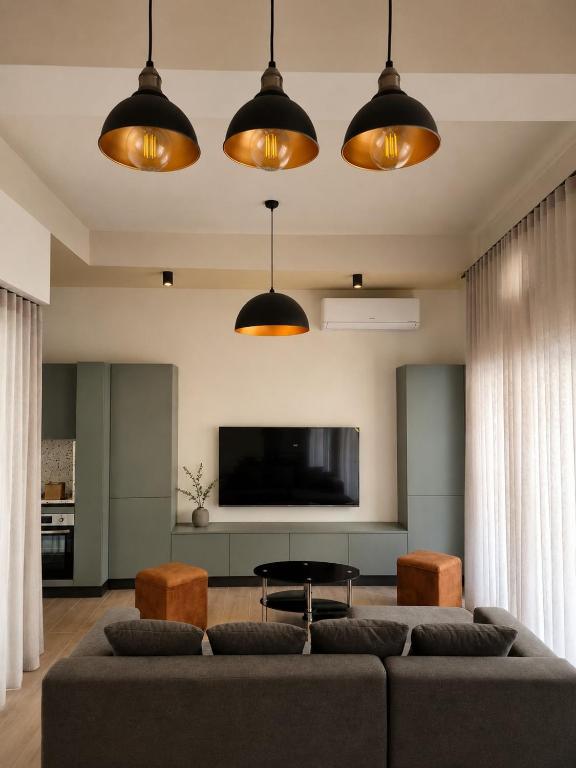 a living room with a couch and a tv at Modern Designer Apartment Private Yard in Hamrun