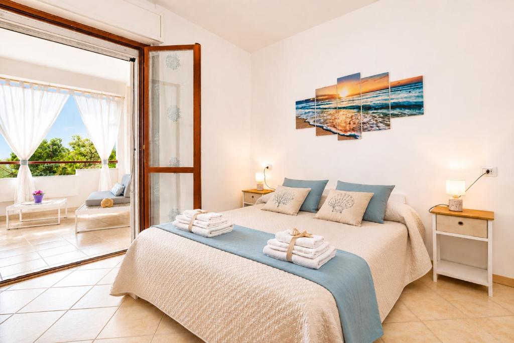 a bedroom with a bed and a large window at Quiet Home in Pula