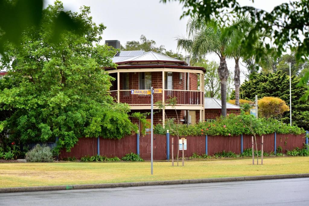 
a house that has a fence around it at Anchorage Guest House and Self-contained Accommodation in Rockingham
