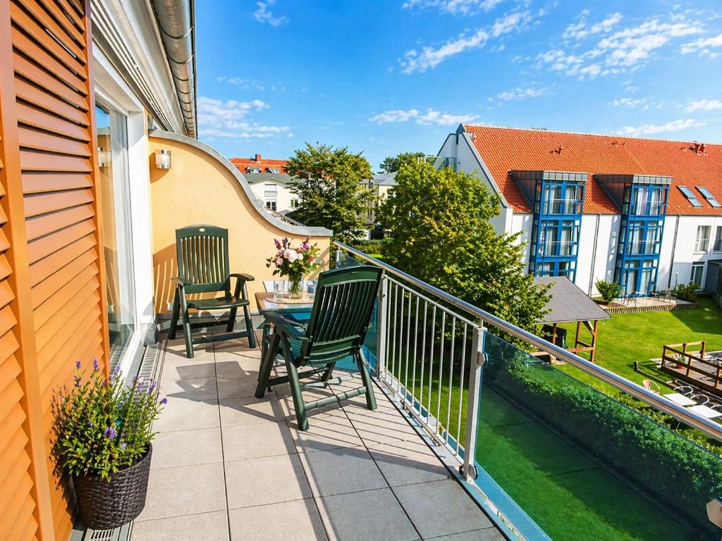 a balcony with chairs and a table on a house at Bella Casa 35 in Juliusruh