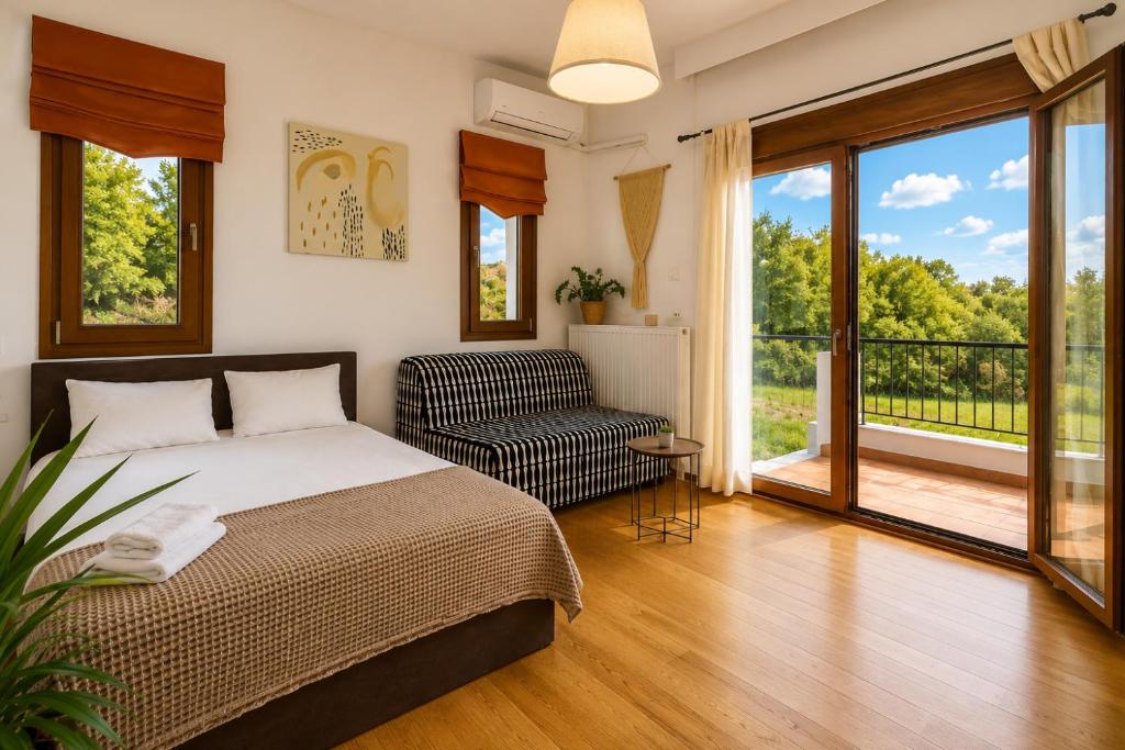 a bedroom with a bed and a chair and windows at Suite Acropolis Serres Parking EV Next to Center in Serres