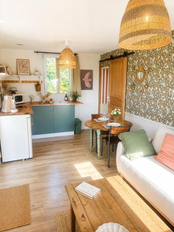 a living room with a couch and a table at Le Nid de Lou in Aire