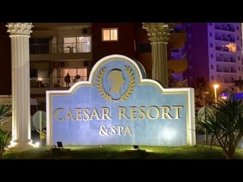 a sign for a caesar resort and spa at night at Caesar Resort spa in Dherinia