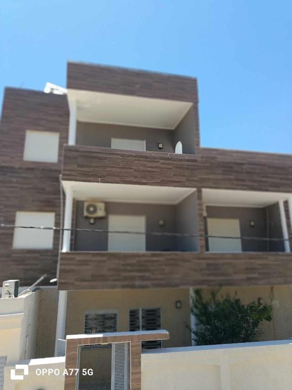 a tall building with balconies on top of it at Family Yahia in Ḩammām al Ghazzāz