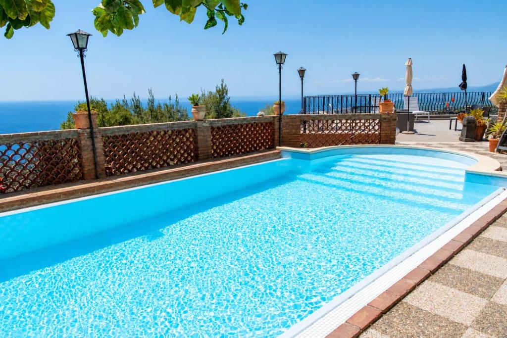 a swimming pool with a view of the ocean at Sarah apartment in Taormina