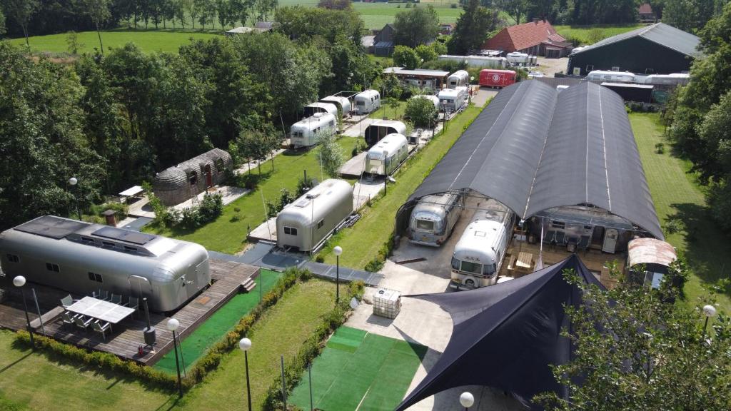 an aerial view of a bunch of trucks parked in a field at Tin Can Town Oirschot in Oirschot