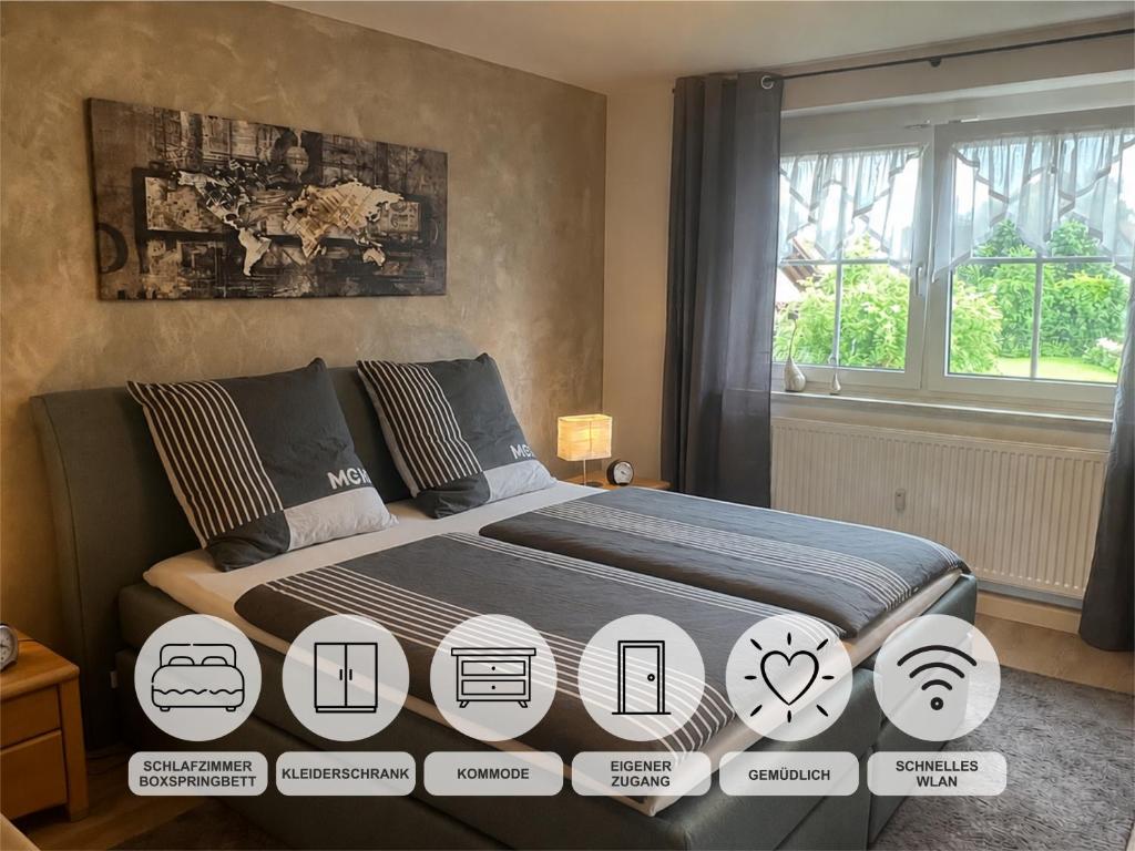 a bedroom with a bed with posters on it at Ferienwohnung Monika Ruhe & Natur nahe Bayreuth in Goldkronach