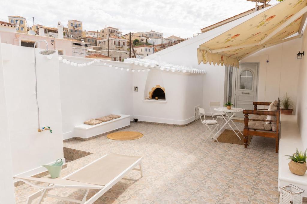 a living room with a table and a fireplace at Emerald Courtyard House in Kranidi