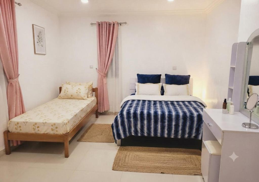 a bedroom with a bed and a bench in it at MSM DIAMOND guesthouse 1 in Male City