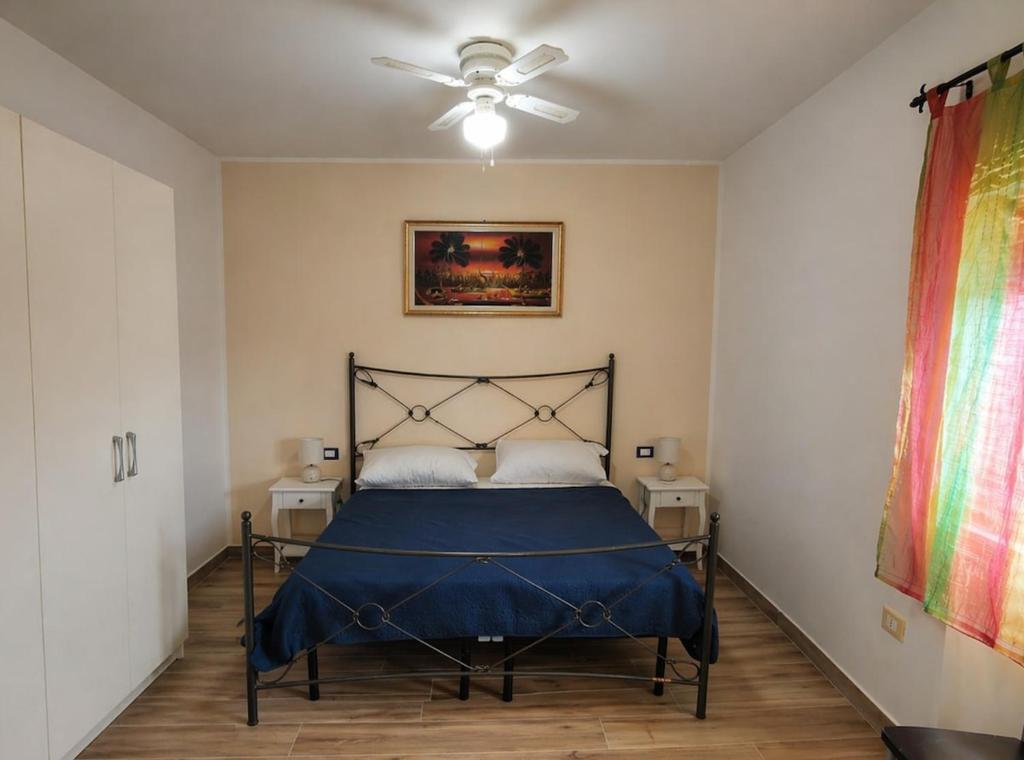 a bedroom with a bed and a ceiling fan at Penthouse a Silvi Marina in San Silvestro