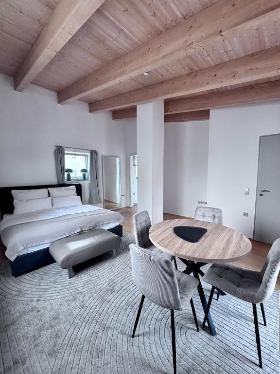 a bedroom with a bed and a table and chairs at PaderCityLoft Apartment Pfau in Paderborn