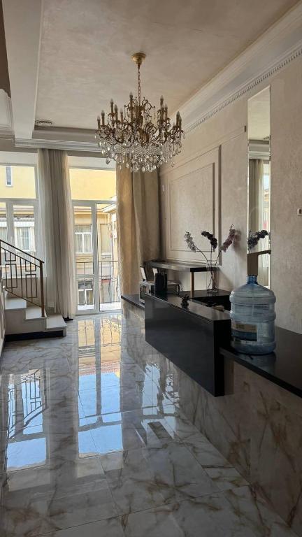 a living room with a chandelier and a marble floor at Monro in Odesa