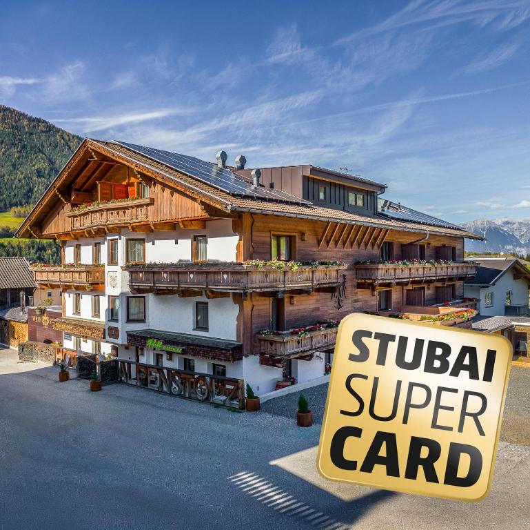 a building with a sign in front of it at Hotel Alpenstolz - Culinary Hideaway Stubai in Mieders