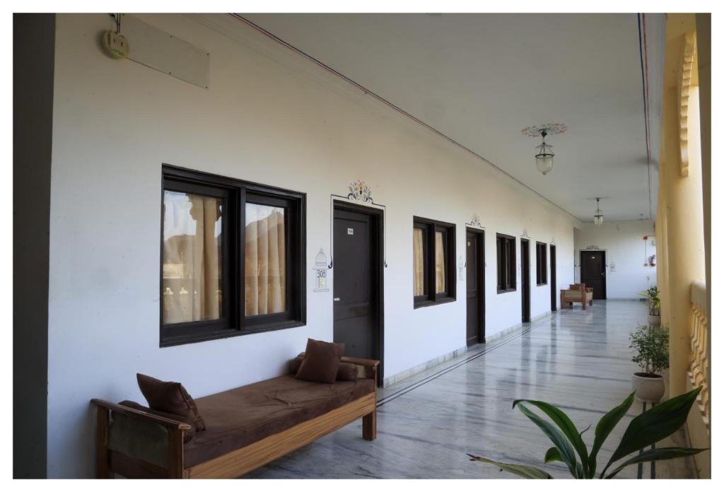 a long hallway with a couch and windows at Atulya Niwas in Udaipur