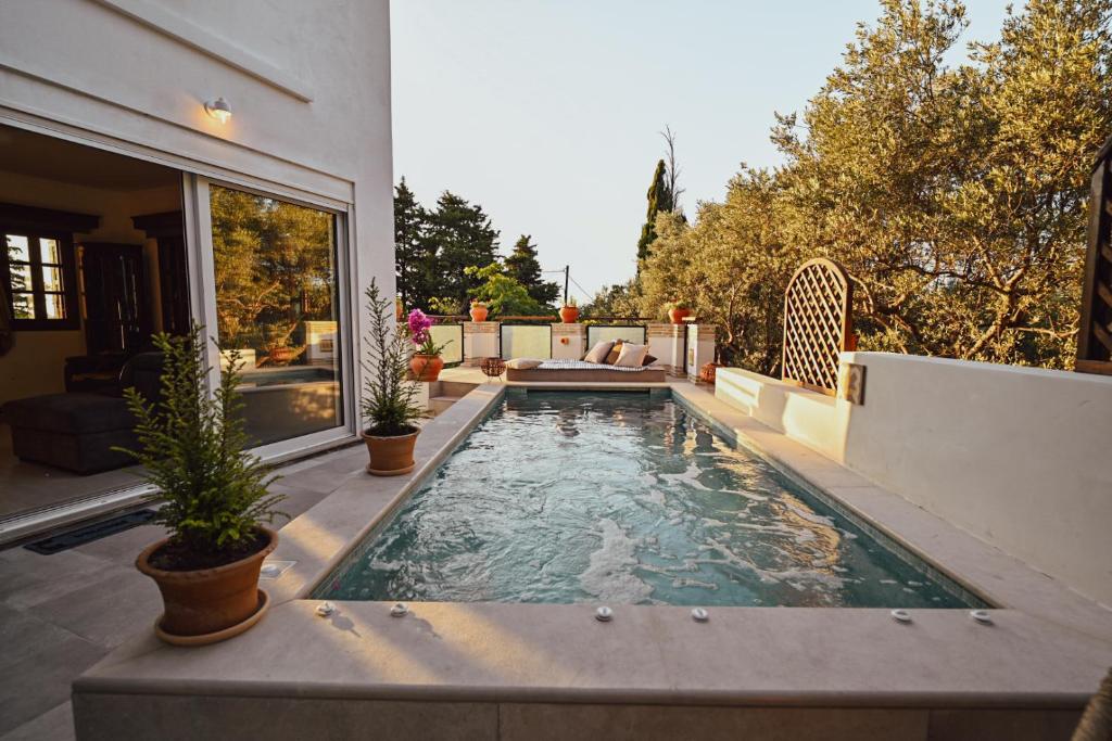 a swimming pool in the backyard of a house at Villa Sea View Gem Steps to Zia Square Hot Tub in Lagoúdi Zía