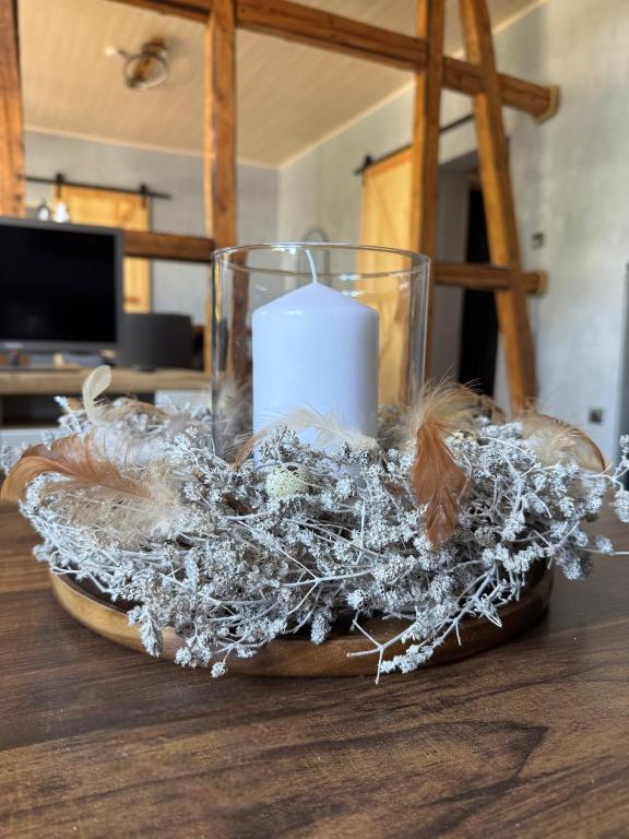 a candle sitting on top of a wooden table at Canossa Lodge in Bad Harzburg