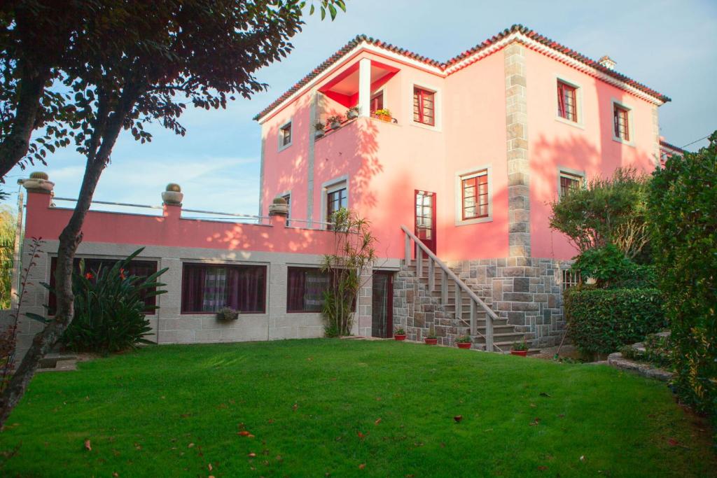a large house with a green lawn in front of it at Quinta Santo António in Sintra