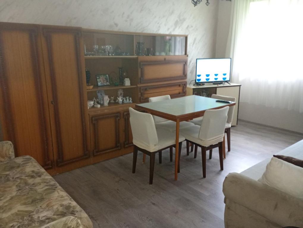 a living room with a table and chairs and a computer at Gordana in Senjski Rudnik