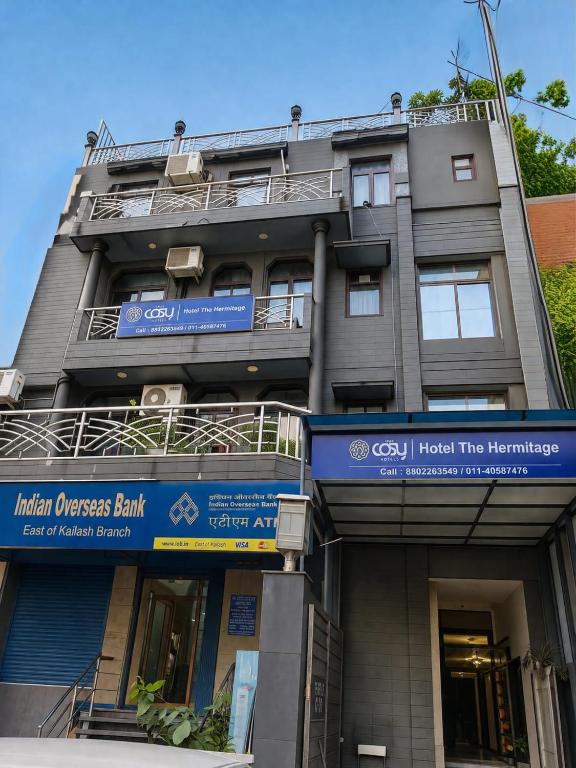 a building with a sign for a hospital at The Hermitage by The Cosy Hotels Near Lotus Temple in New Delhi