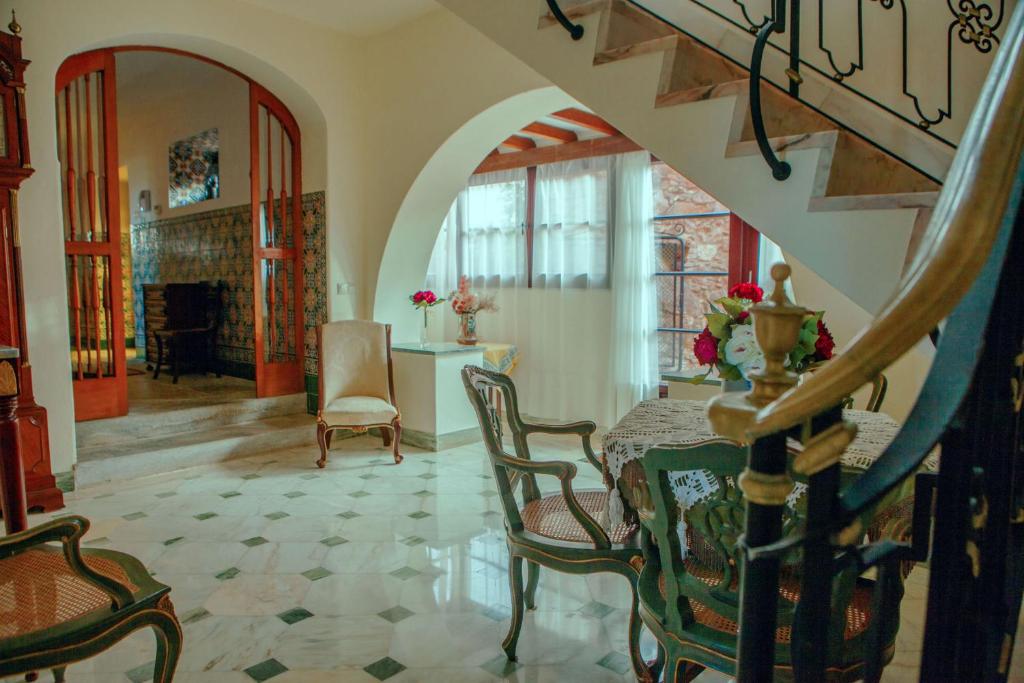 a living room with a table and chairs and a staircase at Quinta Santo António in Sintra