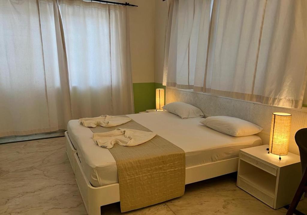 a bedroom with a large bed with towels on it at Beach villa Candolim in Candolim