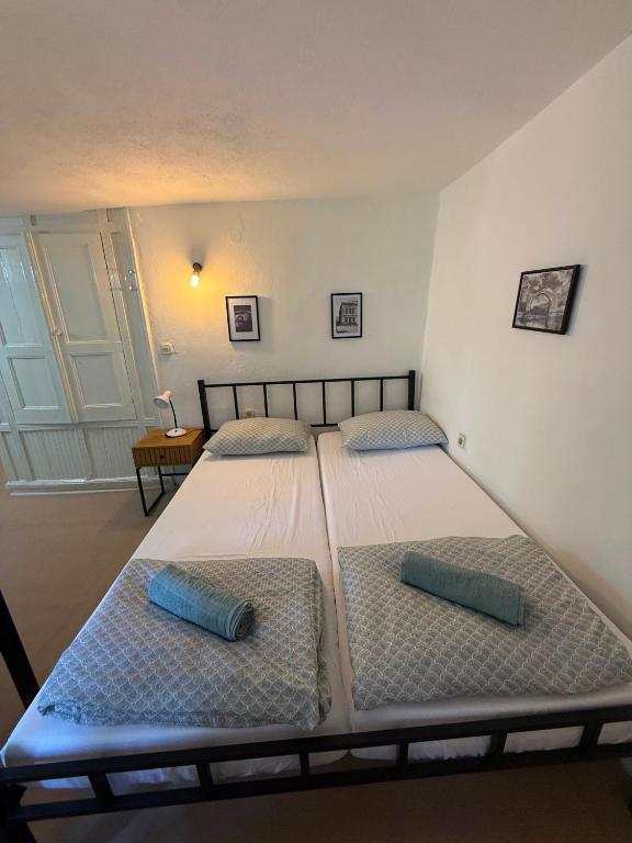 two twin beds in a room with at Bajatova Heritage House with Private Courtyard in Mostar