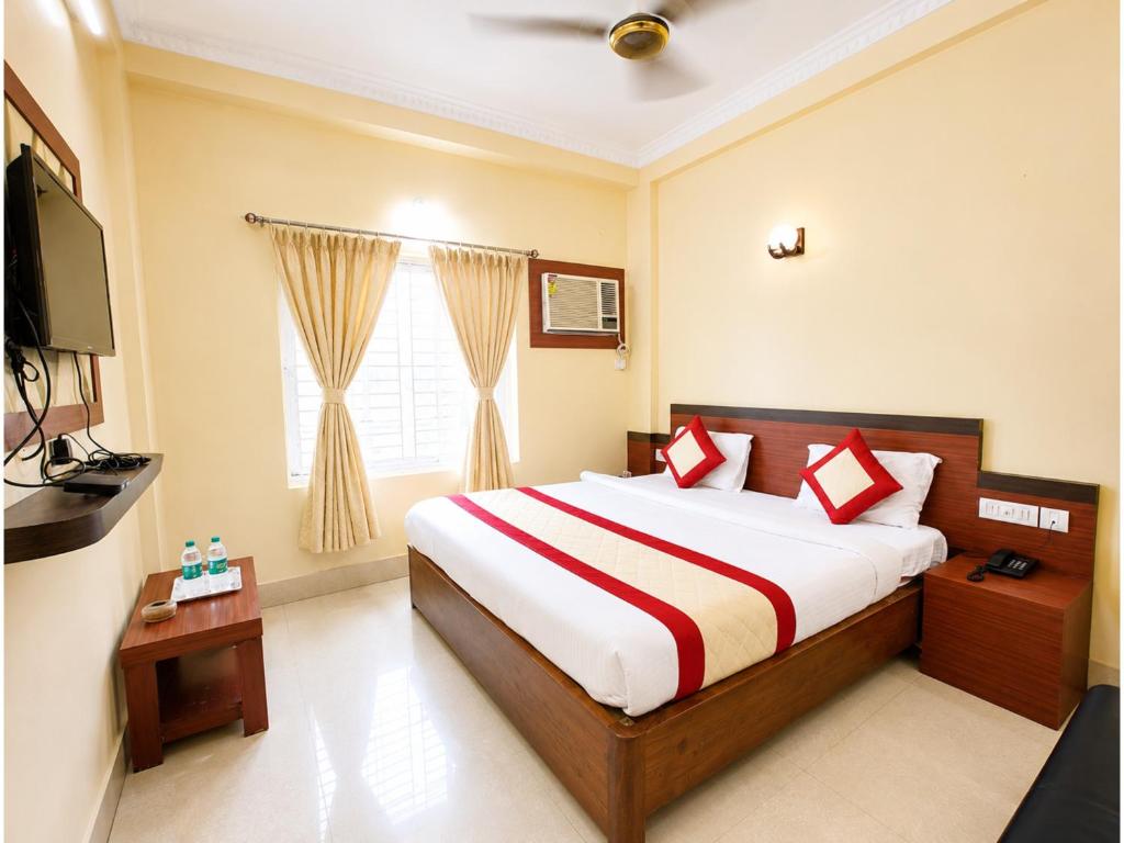 a bedroom with a large bed and a television at The Annapurna Resort Hotel & Restaurant - Walking From 100m From Sea Beach, Free Wifi, Parking Available ! Luxury & Best Hotel in Puri in Puri