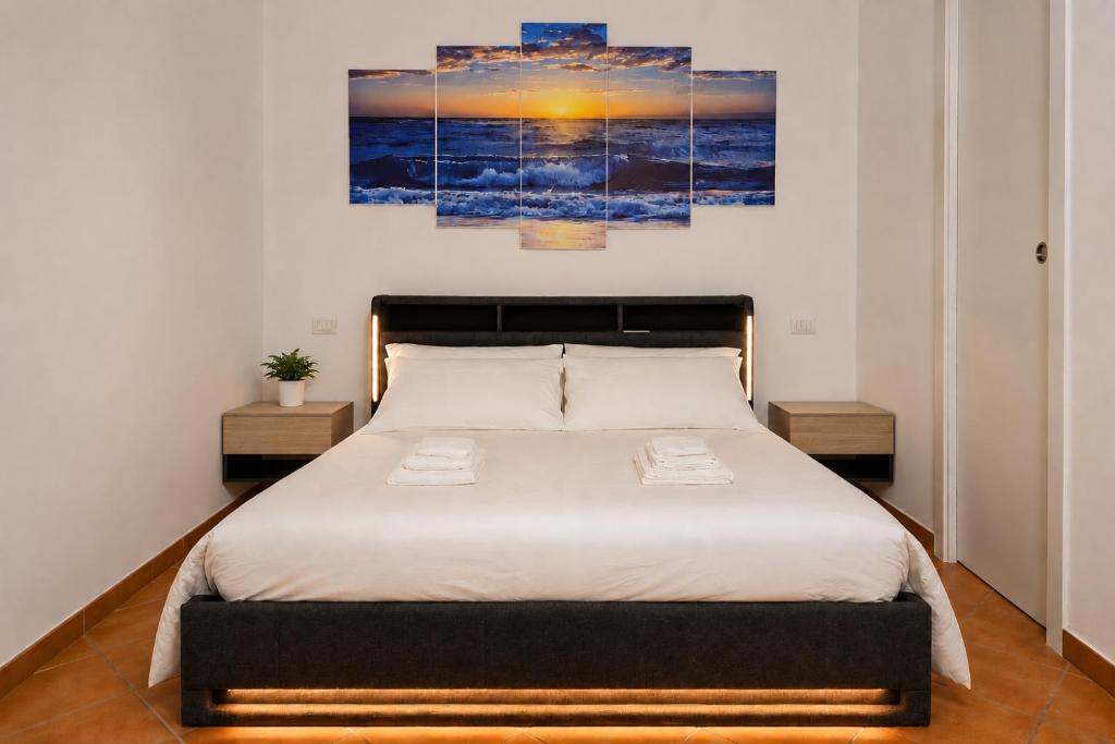 a bedroom with a large bed with two night stands at Le Bonbon in Trevignano Romano